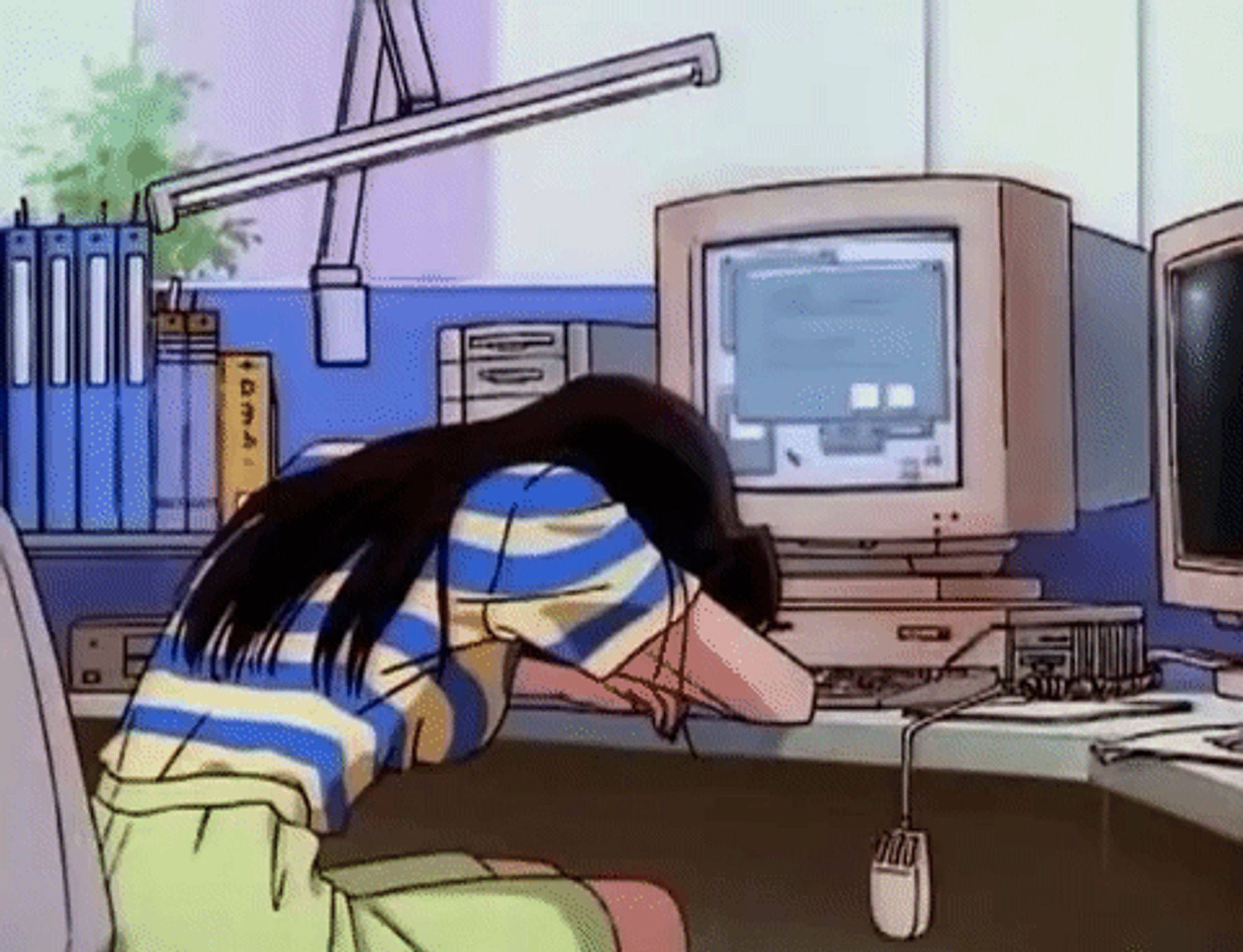 woman with long back hair with her head down against a desk and her arms in front of an old school CRT monitor and a mouse dangling down from the desk