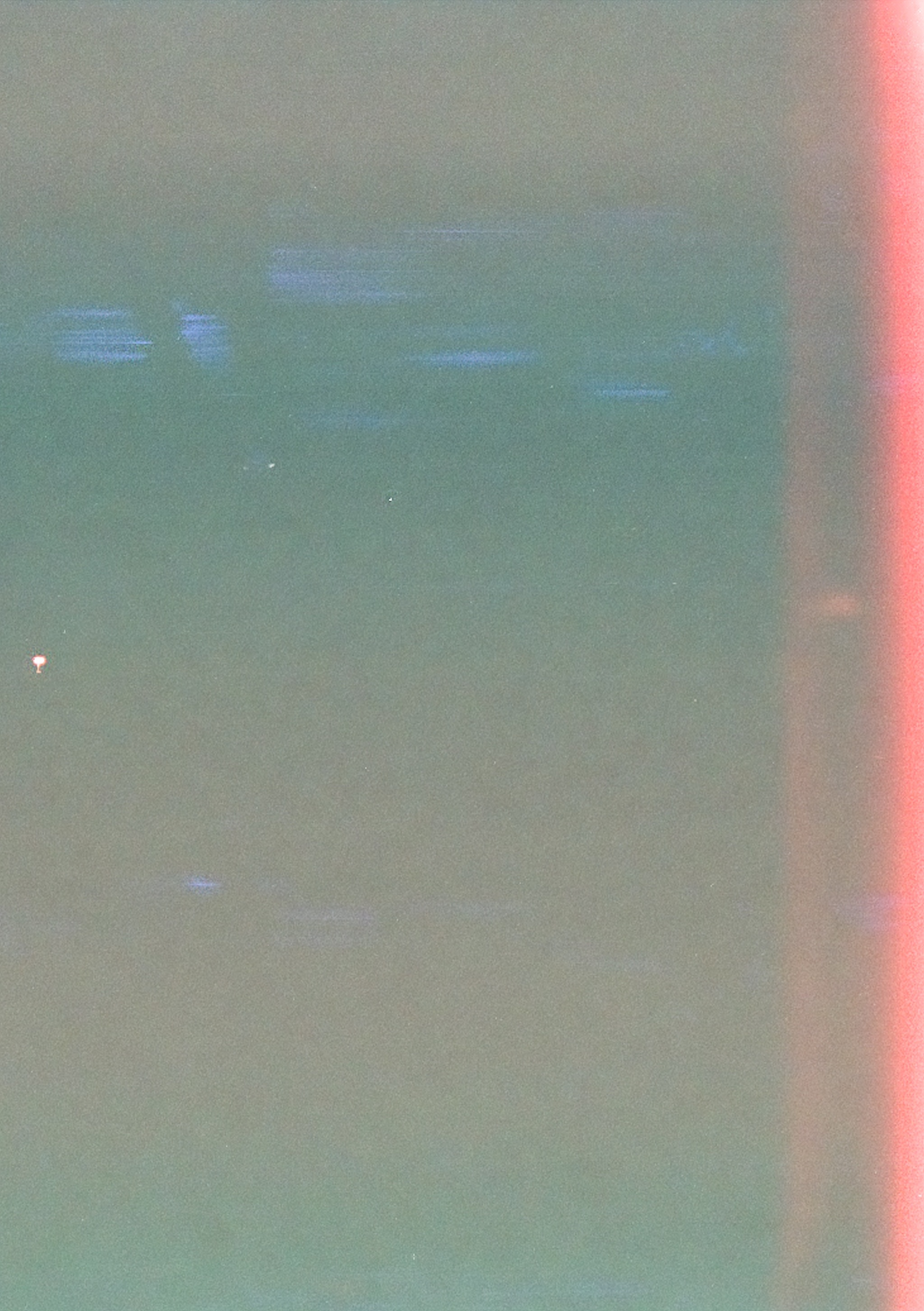 Fuzzy photo largely gray with red light bleeding on the right edge.