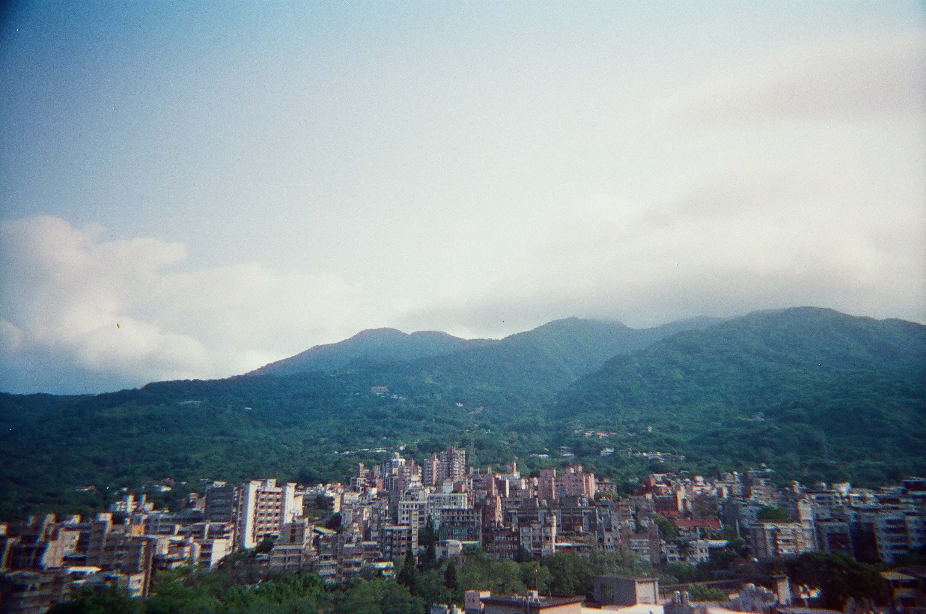 view of mountains and city-scape on a cloudy day.