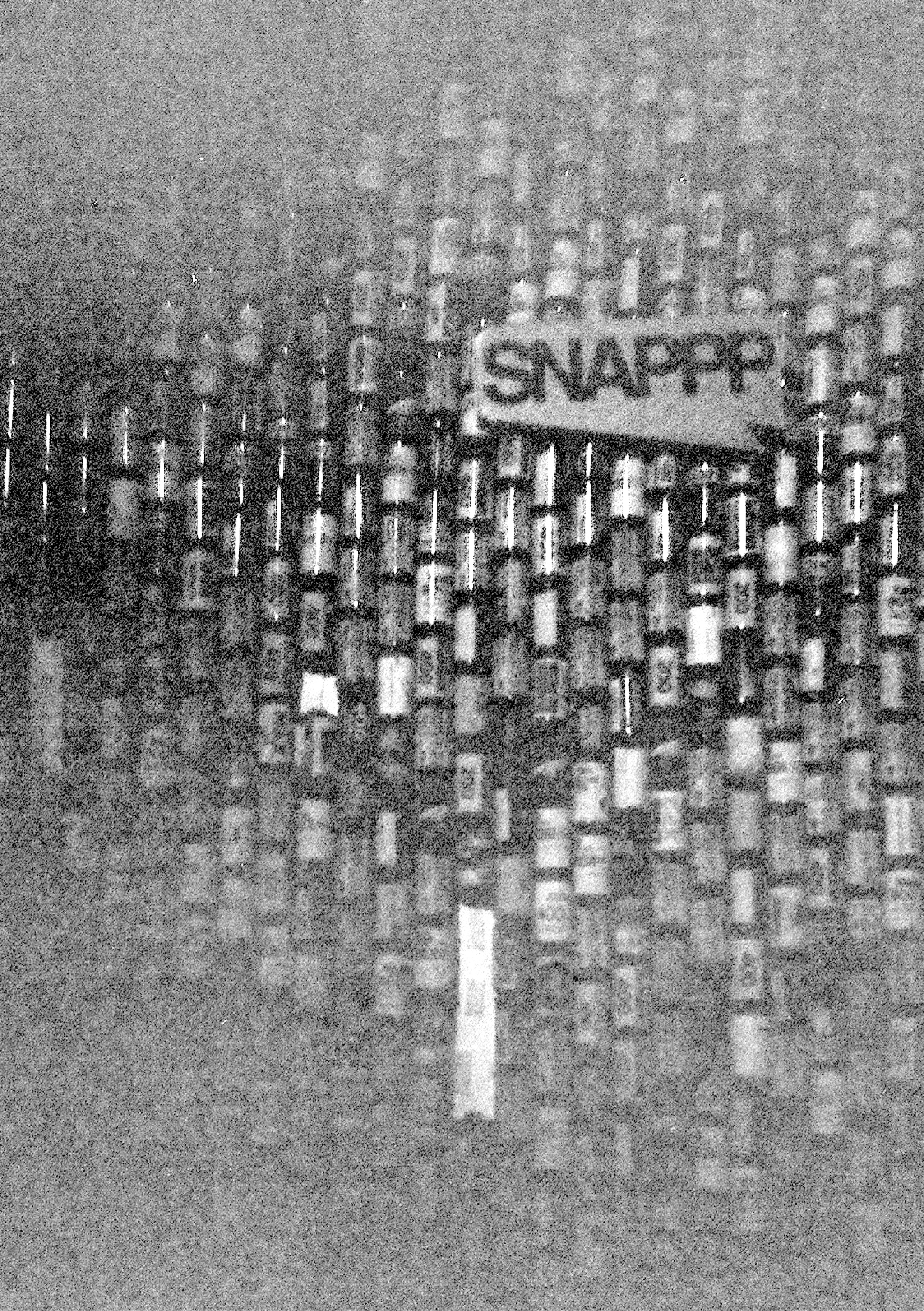 A wall of film rolls, and a sign reading SNAPPP.