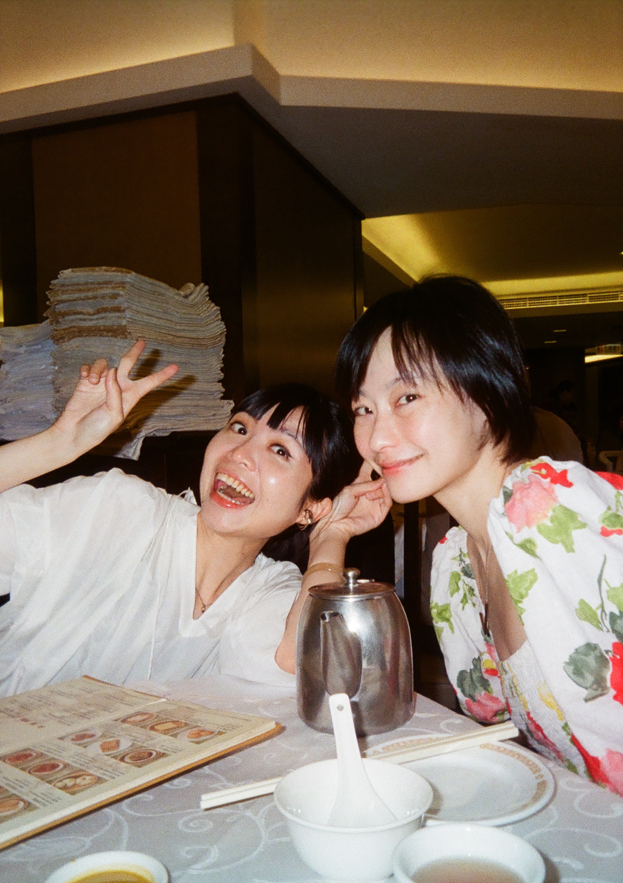 Two woman smiling in a restaurant.